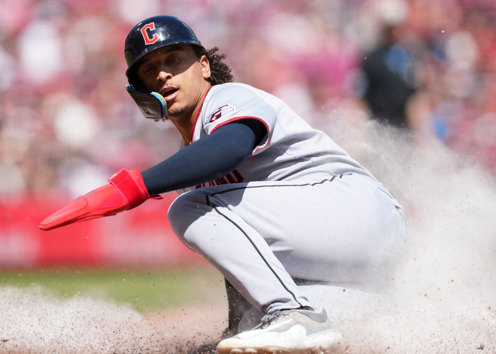Cleveland Guardians' Bo Naylor scores on a single hit by Carlos Santana during the seventh inning of a baseball game against the Cincinnati Reds, Sunday, May 18, 2025, in Cincinnati. (AP Photo/Jeff Dean)
