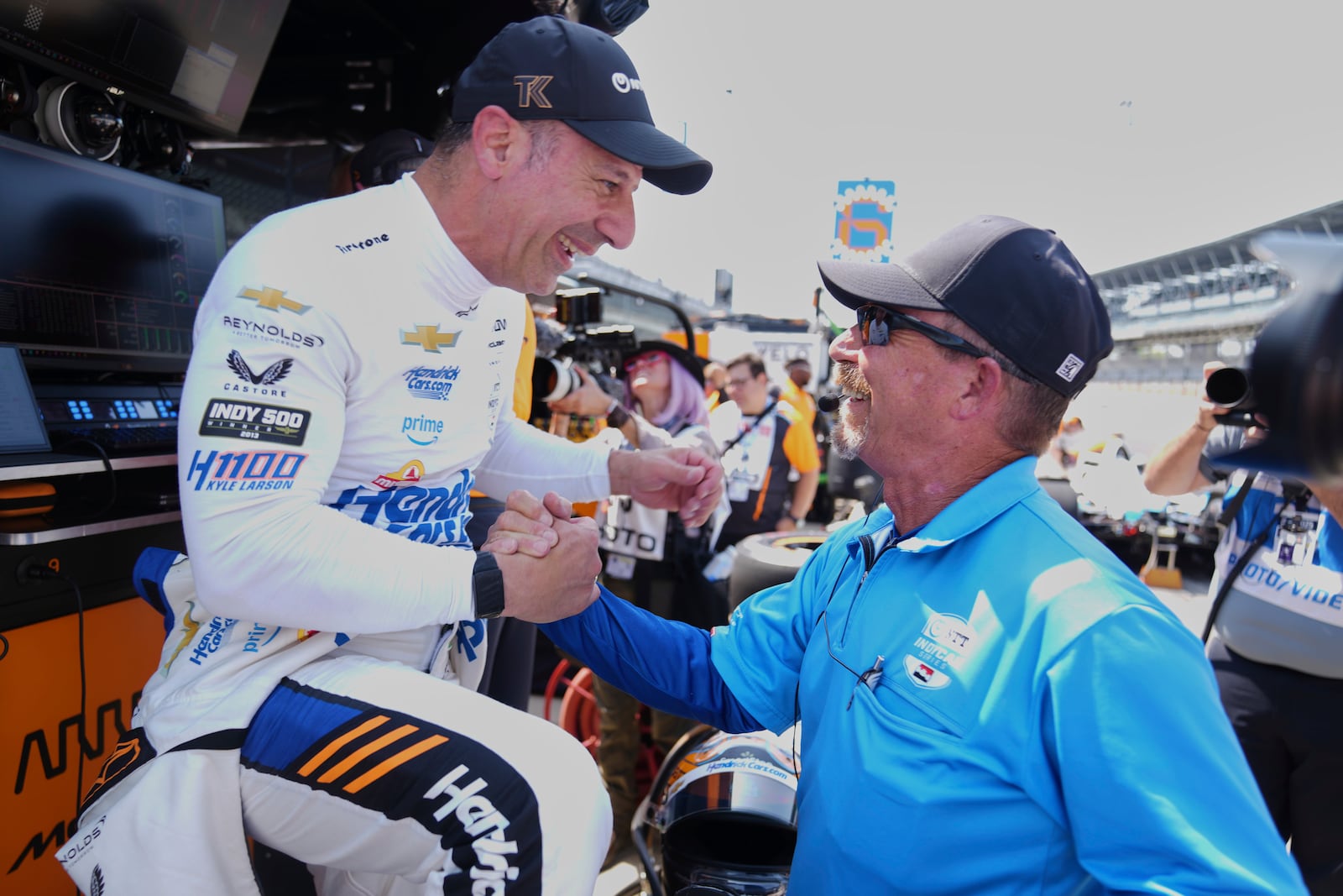 Tony Kanaan, of Brazil, left, is congratulated by Kevin Blanch, Indy Racing League, technical manager after Kanaan completed his refresher test during practice for the Indianapolis 500 auto race at Indianapolis Motor Speedway in Indianapolis, Thursday, May 15, 2025. (AP Photo/Michael Conroy)