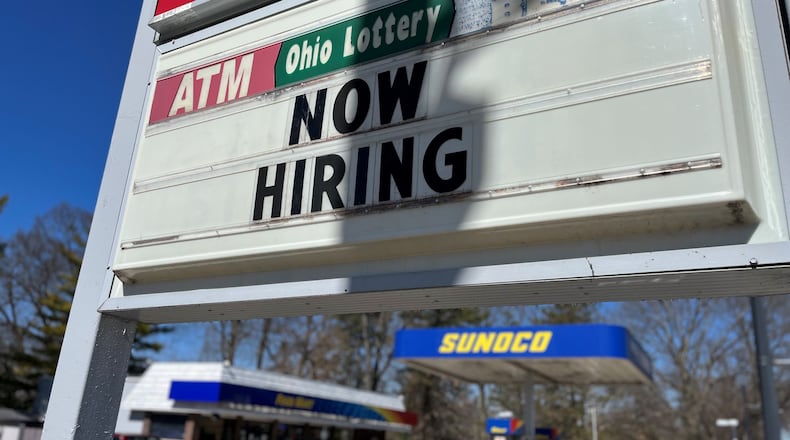 A now hiring sign at a Sunoco in Dayton. The Dayton region saw a big increase in hiring in January. CORNELIUS FROLIK / STAFF