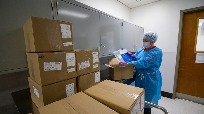 Yvonne Young, central sterilization and dispensing manager, receives shipment of swabs in Central Sterilization at the College of Dentistry, in Postle Hall at The Ohio State University. CONTRIBUTED