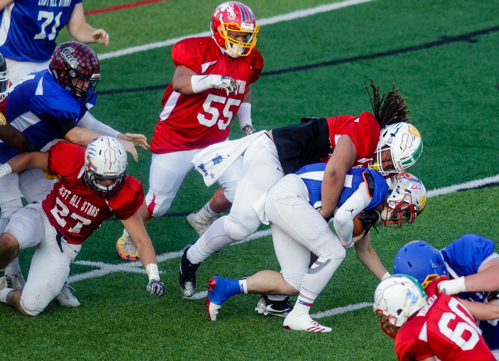 East quarterback Seth Becker of Bethel-Tate is dropped by the West’s Jason Smith of Hamilton during the 43rd Southwestern Ohio Football Coaches Association Ron Woyan East-West All-Star Game on Thursday night at Kings. NICK GRAHAM/STAFF