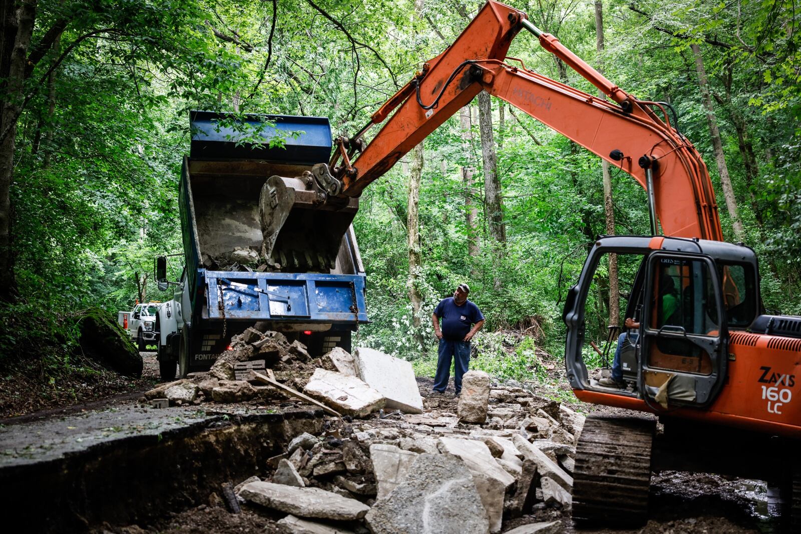 Crew work Monday June 21, 2021 fix Cook Rd. in Spring Valley Twp. after storm on Friday washed out the road. Jim Noelker/Staff