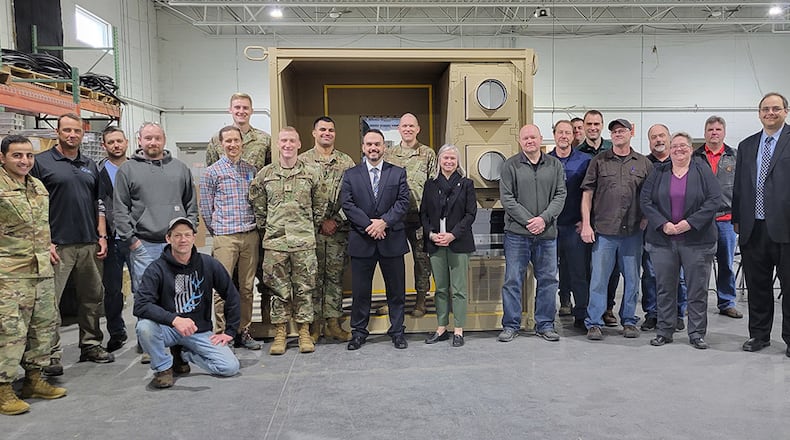 Lea Kirkwood (center), program executive officer and director of the Agile Combat Combat Support Directorate, is pictured with team members responsible for responsible for developing and fielding the Negatively Pressurized Conex and NPC Lite. The team marked the delivery of the final NPCL during a ceremony on March 1. U.S. AIR FORCE PHOTO/LT. COL. PAUL HENDRICKSON