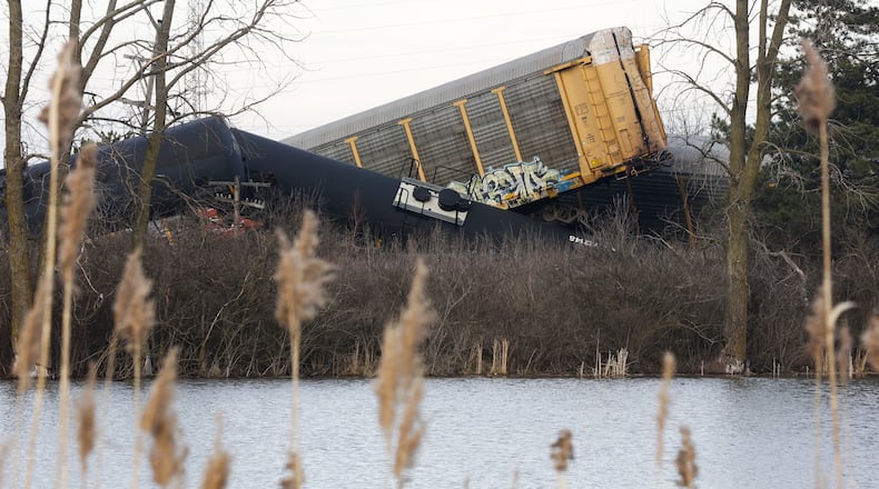 Multiple cars of a Norfolk Southern cargo train lie toppled on one another after derailing at a train crossing with Ohio 41 in Clark County, Ohio, Saturday, March 4, 2023. (Bill Lackey/Springfield-News Sun via AP)