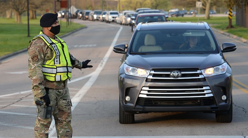 Staff Sgt. Jacob Reyes, a unit training inspector with the 88th Security Forces Squadron, directs traffic entering Gate 12A as it flows through all lanes on April 19 at Wright-Patterson Air Force Base. U.S. AIR FORCE PHOTO/TY GREENLEES