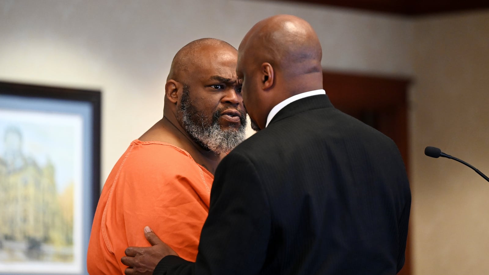 Jerome Collier, 51, of Hamilton, (pictured talking with attorney David Washington) and Dy'Shonna Goins, of Kettering, were arrested following a June 16 incident that resulted in the death of Jesse Jones, 36, of Middletown, at Bar II. Collier was charged with several felonies, including murder, including an underlying gun specification. Goins was charged with multiple counts of felonious assault, as well as an underlying gun specification. Both appeared in Butler County Common Pleas Court on Tuesday, July 1, 2025. MICHAEL D. PITMAN/STAFF