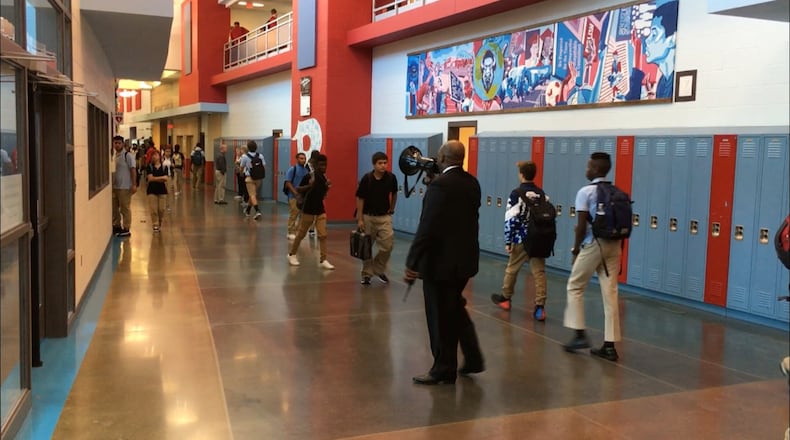 Belmont High School Principal Donetrus Hill monitors school hallways last August, urging students to get to their next class on time. JEREMY P. KELLEY / STAFF