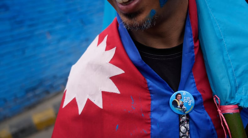 A supporter of Rastriya Swatantra Party celebrates the victory of Ranju Darshana, a candidate for a seat in the House of Representatives in Kathmandu, Nepal, Friday, March 6, 2026. (AP Photo/Niranjan Shrestha)