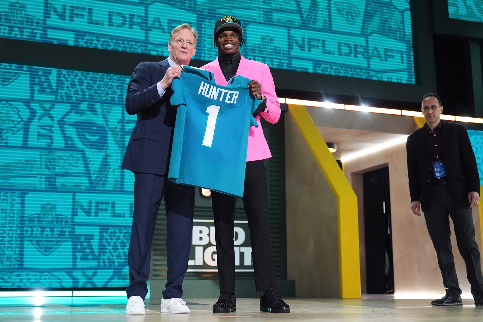 Colorado wide receiver Travis Hunter, right, poses with NFL Commissioner Roger Goodell after being chosen by the Jacksonville Jaguars with the second overall pick during the first round of the NFL football draft, Thursday, April 24, 2025, in Green Bay, Wis. (AP Photo/Jeff Roberson)