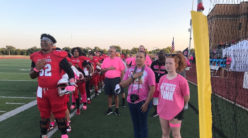 Ebonie Sherwood (with camera) joins the Stebbins team for the National Anthem before Friday night's game. Tom Archdeacon/CONTRIBUTED