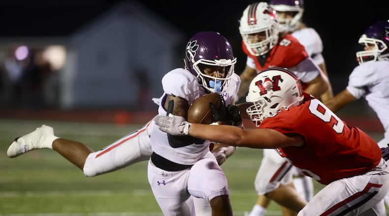 Pickerington Central's Kaejuan Alexander is tackled by Wayne's JD Bryant on Friday, Aug. 30, 2024, at Heidkamp Stadium in Huber Heights. David Jablonski/Staff