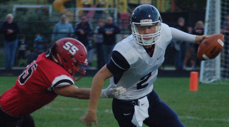 Valley View quarterback Collin Wood eludes the tackle of Madison’s Levi Wilson earlier this season at Madison High School. Valley View won 32-7. JOHN CUMMINGS / CONTRIBUTED