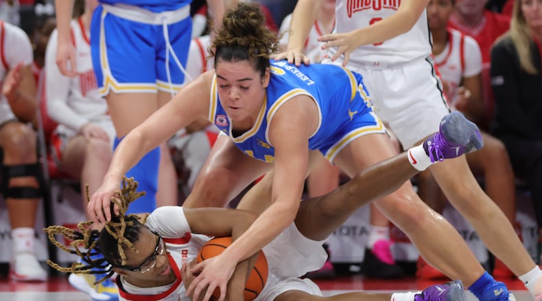 Ohio State guard Jaloni Cambridge, bottom, grabs the ball against UCLA guard Charlisse Leger-Walker, top, during the first half of an NCAA college basketball game in Columbus, Ohio, Sunday, Dec. 28, 2025. (AP Photo/Paul Vernon)