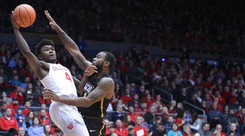 Dayton’s Jordan Davis scores and is fouled by Virginia Commonwealth’s Mike’l Simms on Friday, Jan. 12, 2018, at UD Arena. David Jablonski/Staff