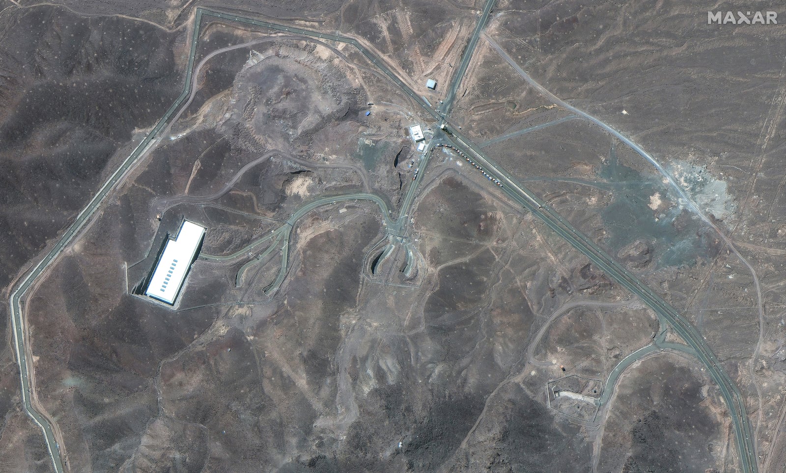 This satellite image provided by Maxar Technologies shows vehicles at Fordo enrichment facility in Iran on Thursday, June 19, 2025. (Maxar Technologies via AP)