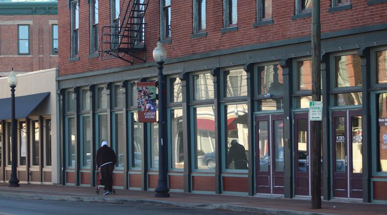 A pedestrian walks along the 1100 block of E. Third St. CORNELIUS FROLIK / STAFF