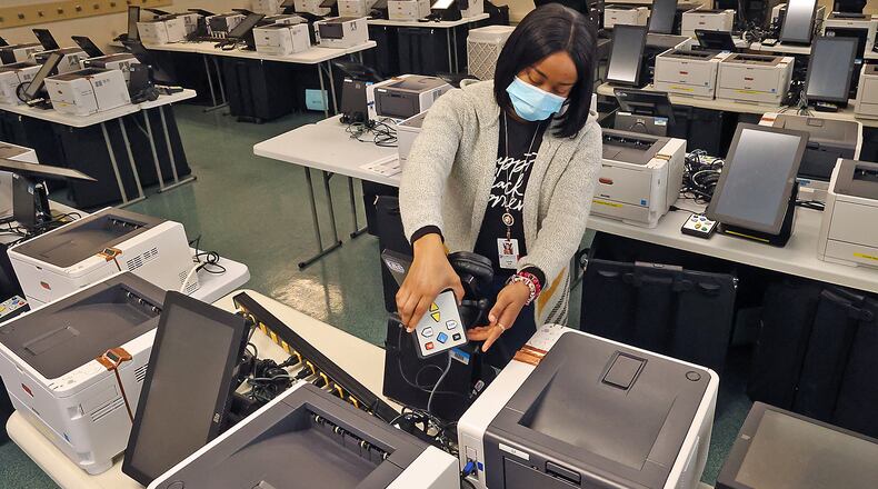 Camille Hall, from the Clark County Board of Elections, sets up accessible voting equipment for disabled voters for testing next week at the Board of Elections Friday, March 25, 2022. BILL LACKEY/STAFF