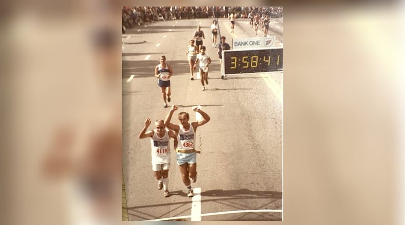 Larry Smith and Harry Bradbury raise their arms in triumph as they finish the 1983 Columbus Marathon in 3 hours and 48 minutes. “I had tears in my eyes,” Bradbury said. CONTRIBUTED PHOTO
