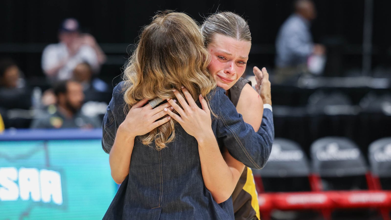 Alter senior forward Maddie Moody embraces Alter principal Lourdes Lambert after Lambert presented Moody with her individual medal following the Knights' 40-29 loss in the Division IV state final on Friday at University of Dayton Arena. Moody, the team's lone senior, scored 12 points and brought down nine rebounds. BRYANT BILLING / STAFF