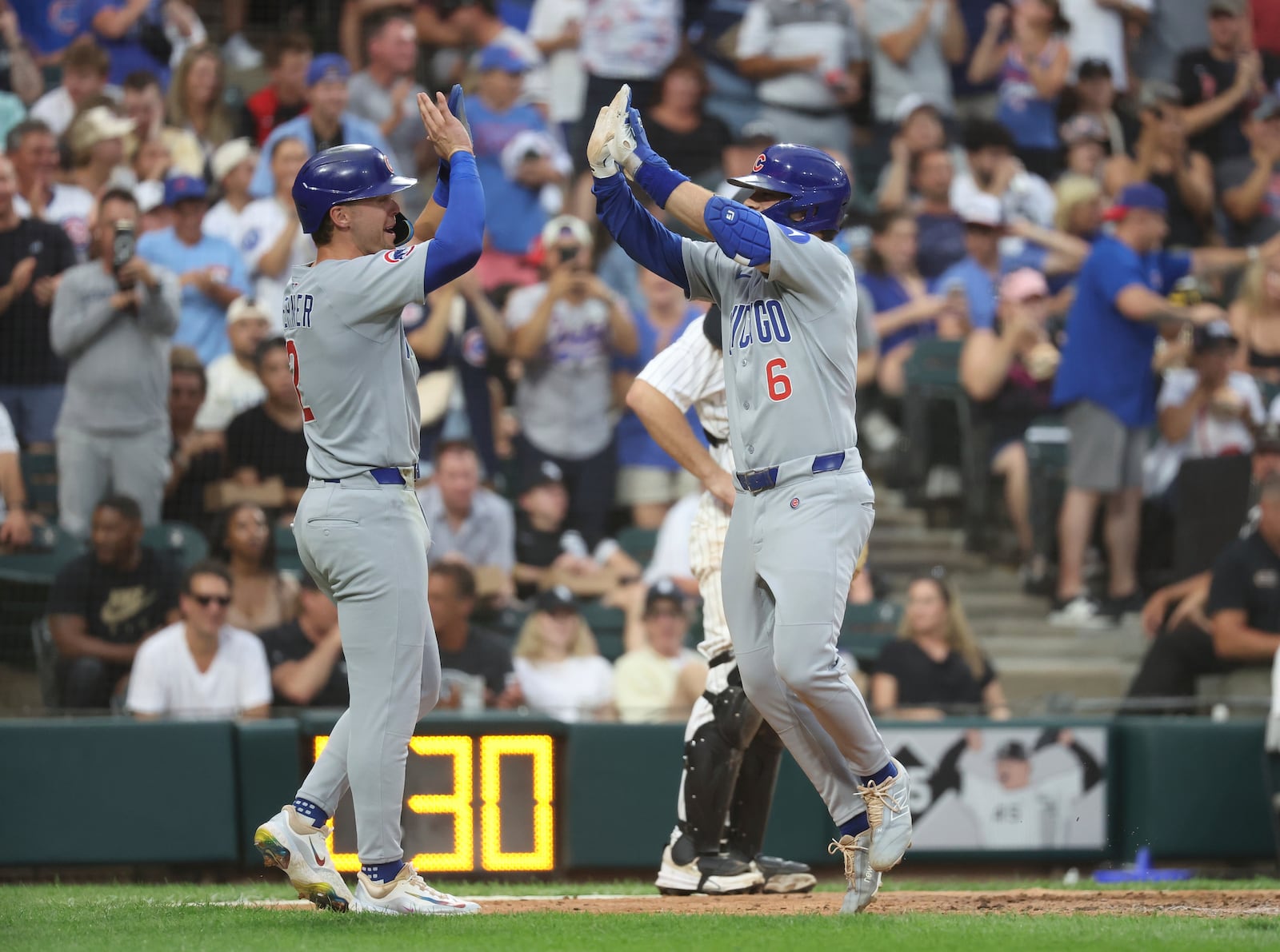Chicago Cubs second baseman Nico Hoerner (2) and Chicago Cubs third baseman Matt Shaw (6) celebrate a two run home run during the seventh inning of a baseball game between the Chicago Cubs and Chicago White Sox, Saturday, July 26, 2025, in Chicago. (AP Photo/Talia Sprague)