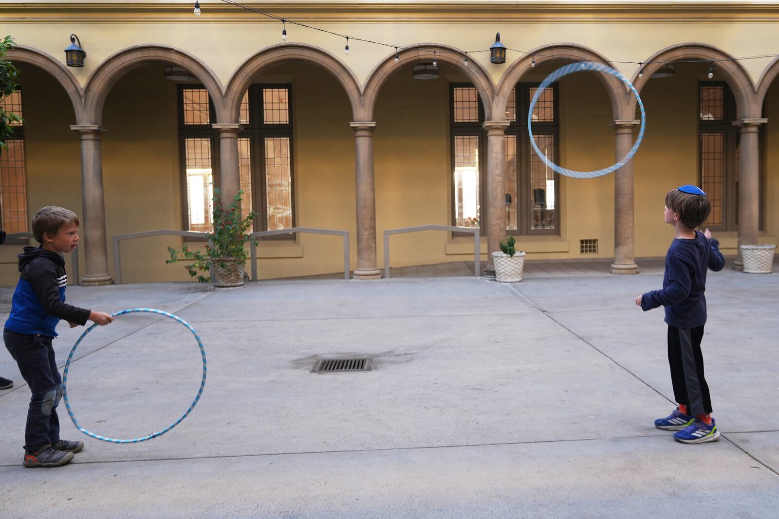 Congregants children of the 104-year-old Pasadena Jewish Temple and Center which burned down in the Jan. 2025 Eaton fire, play with rings before gathering for a Passover Seder at the First United Methodist Church in Pasadena, Calif., on Friday, April 4, 2025. (AP Photo/Damian Dovarganes)