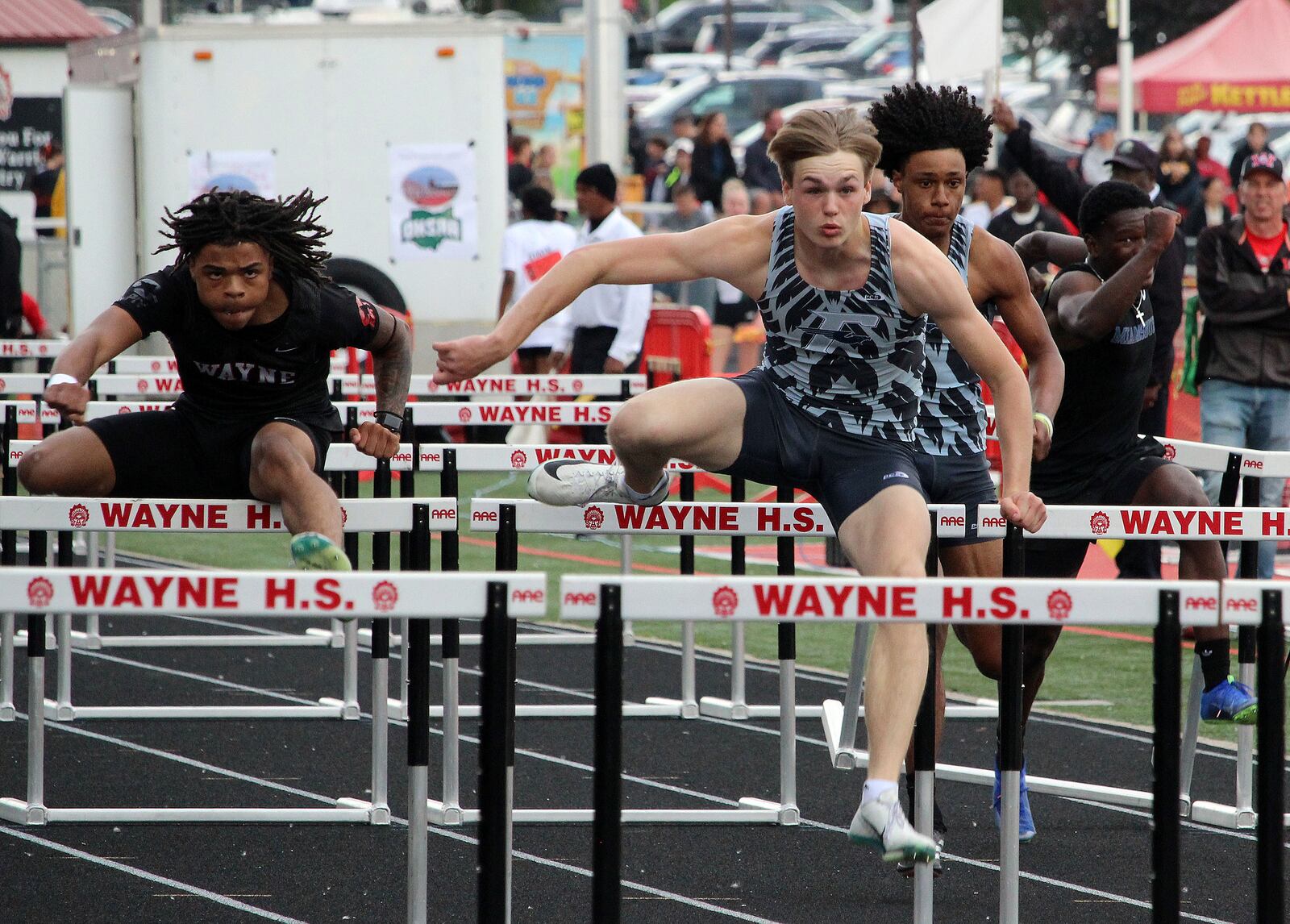 Fairmont's Logan Wilkins (middle front) and Wayne's Keng Martin (left) comete in the 110 high hurdles during the Division I Region 4 track finals at Wayne's Heidkamp Stadium. HENRY S. CONTE / CONTRIBUTED PHOTO