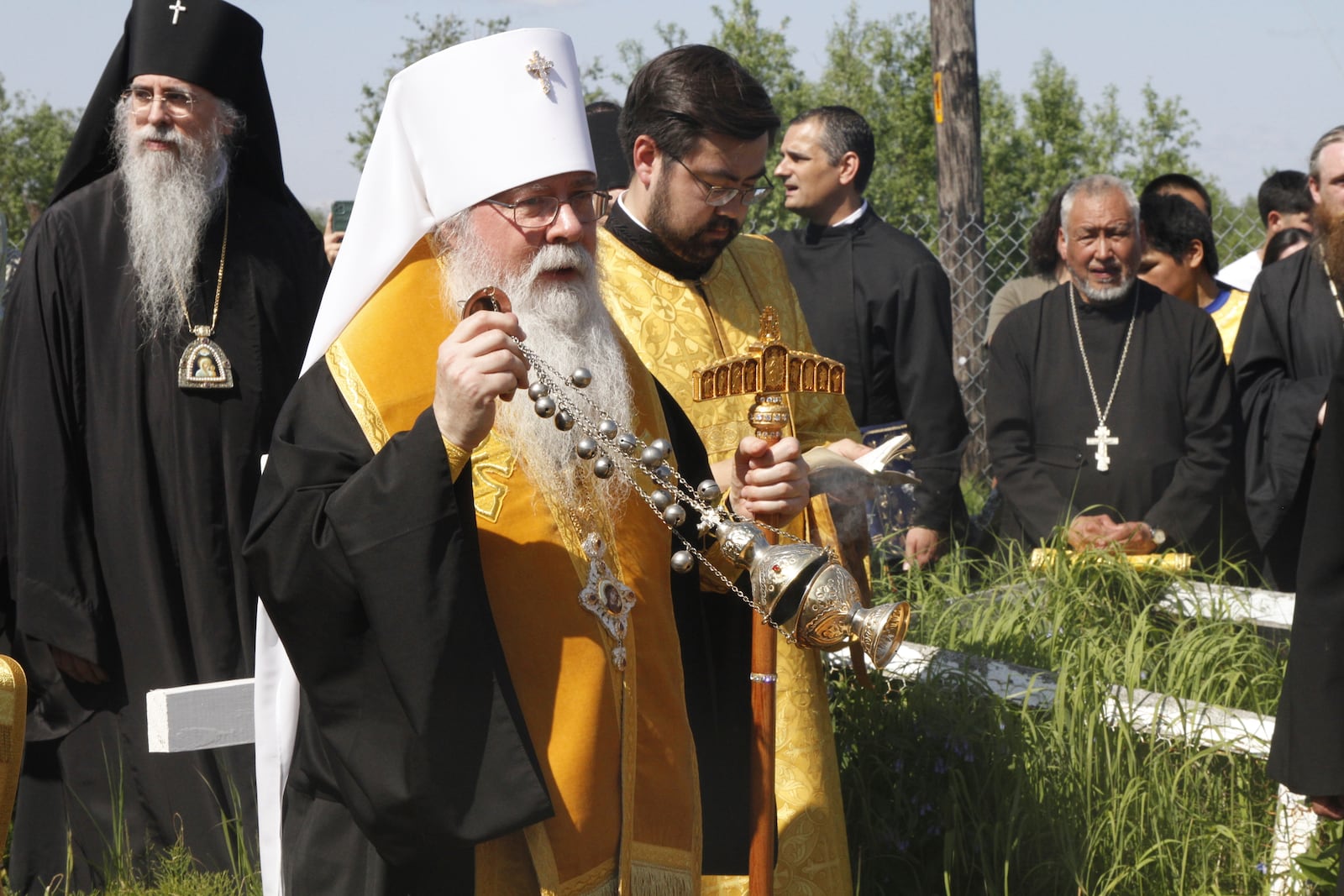Metropolitan Tikhon, the head of the Orthodox Church in America, swings a censer as he blesses the remains of Matushka Olga Michael before a ceremony that made her the first female Orthodox saint in North America, in Kwethluk, Alaska, on June 19, 2025. (AP Photo/Mark Thiessen)