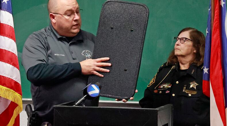 Clark County Sheriff Deb Burchett and Maj. Chris Clark talk about the new ballistic shields they were able to supply to every member of their department thanks in part to a fundraiser at Brandeberry Winery  in Enon.  BILL LACKEY/STAFF