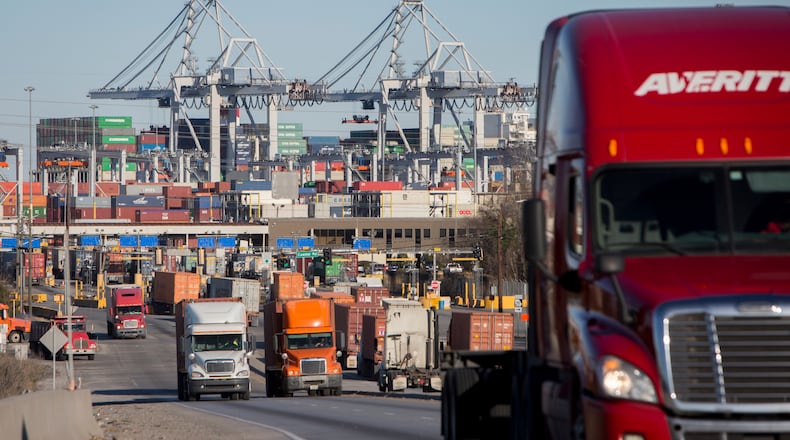 FILE- Tractor-trailers move cargo out of the Port of Savannah in Savannah, Ga., Jan. 30, 2018. (AP Photo/Stephen B. Morton, File)