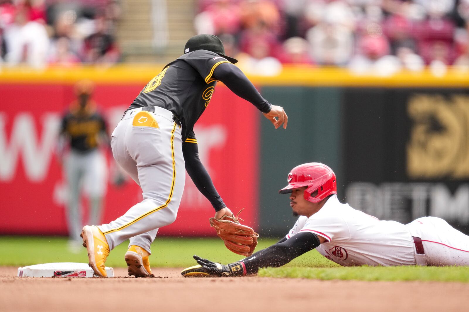 Cincinnati Reds' Noelvi Marte, right, steals second base against Pittsburgh Pirates second baseman Enmanuel Valdez during the fifth inning of a baseball game, Sunday, April 13, 2025, in Cincinnati. (AP Photo/Jeff Dean)