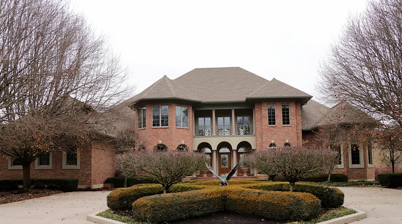 The brick house with about 9,580 sq. ft. of living space has three levels accessible by an open staircase or elevator and includes 4 bedrooms, 4 full bathrooms, a full, finished lower level with kitchen, 12-person island wet bar, theater room, game room, formal areas and casual spaces. CONTRIBUTED PHOTO BY KATHY TYLER