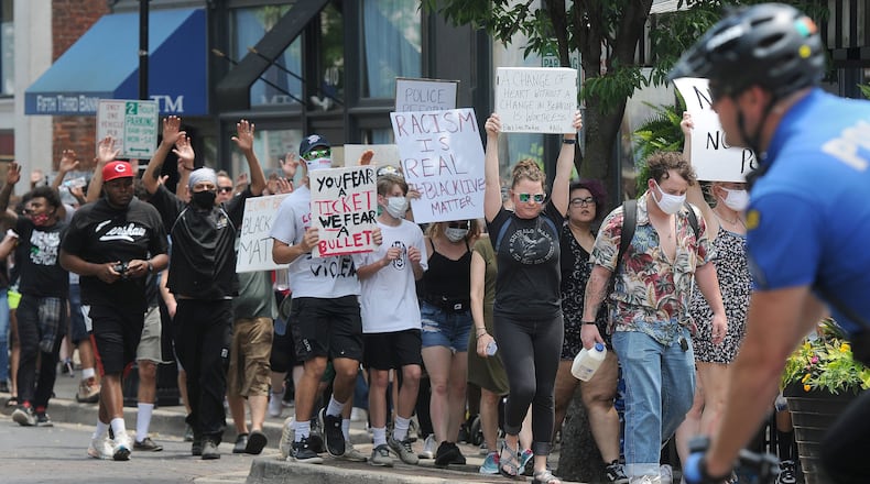 Peaceful protesters marched through the Oregon District recently. MARSHALL GORBYSTAFF