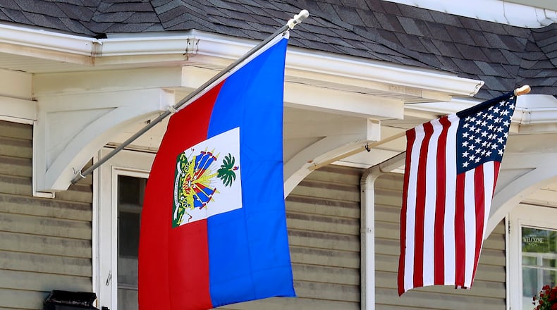 A residence along North Limestone Street in Springfield was flying the Haitian flag along side the American flag Wednesday, May 10, 2023. BILL LACKEY/STAFF