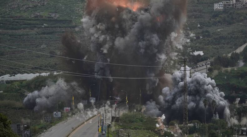 Smoke and flames rise from an Israeli airstrike that hit the Qasmiyeh Bridge near the coastal city of Tyre, Lebanon, Sunday, March 22, 2026. (AP Photo/Mohammad Zaatari)