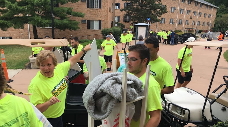 Wright State University faculty senate president Laura Luehrmann helps freshman students move into dorms in August 2019. STAFF PHOTO / HOLLY SHIVELY