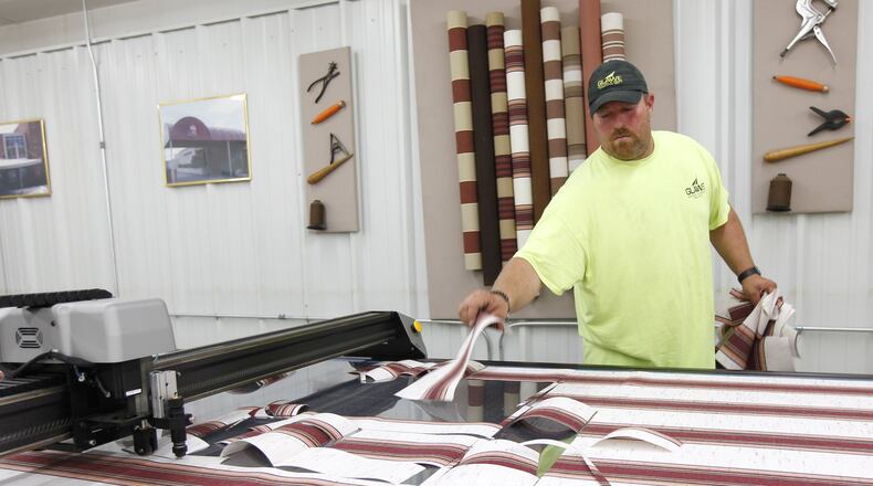 Shaun Fridley, grandson of Glawe’s CEO Vernon Schaefer, operates a digital fabric cutter that saves hours of manual cutting time for custom awnings and tents. TY GREENLEES / STAFF