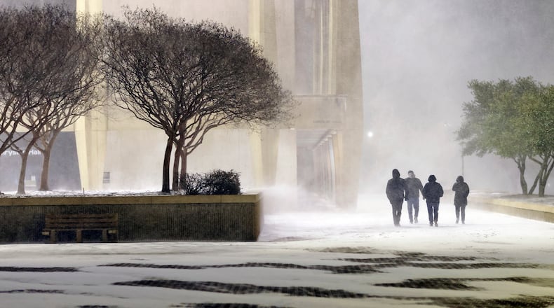 Fans leave in the snow from the ice hockey game between the Norfolk Admirals and the Trois-Rivières Lions at Scope Arena in Norfolk, Va., on Saturday, Jan. 31, 2026. (Peter Casey/The Virginian-Pilot via AP)