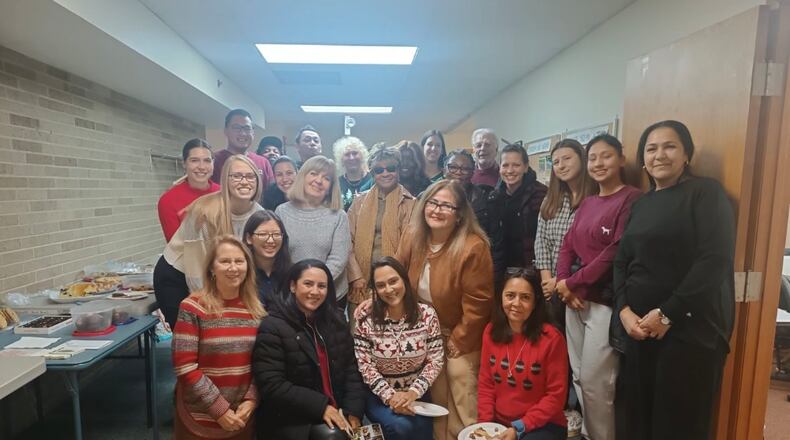 Abiding Christ ESOL program students celebrate the holiday season with an end-of-year party. Students and teachers enjoyed food and activities from various countries.