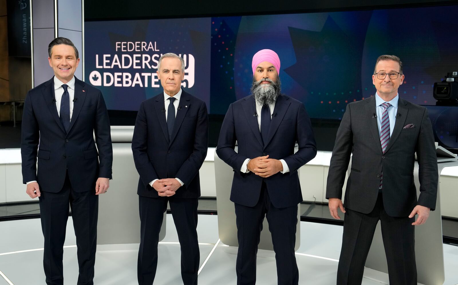 Conservative Leader Pierre Poilievre, from left, Liberal Leader Mark Carney, New Democratic Party Leader Jagmeet Singh, and Bloc Quebecois Leader Yves-Francois Blanchet, take part in a group photo prior participating in the English-language federal leaders' debate, in Montreal, Thursday, April 17, 2025. (Adrian Wyld/The Canadian Press via AP)