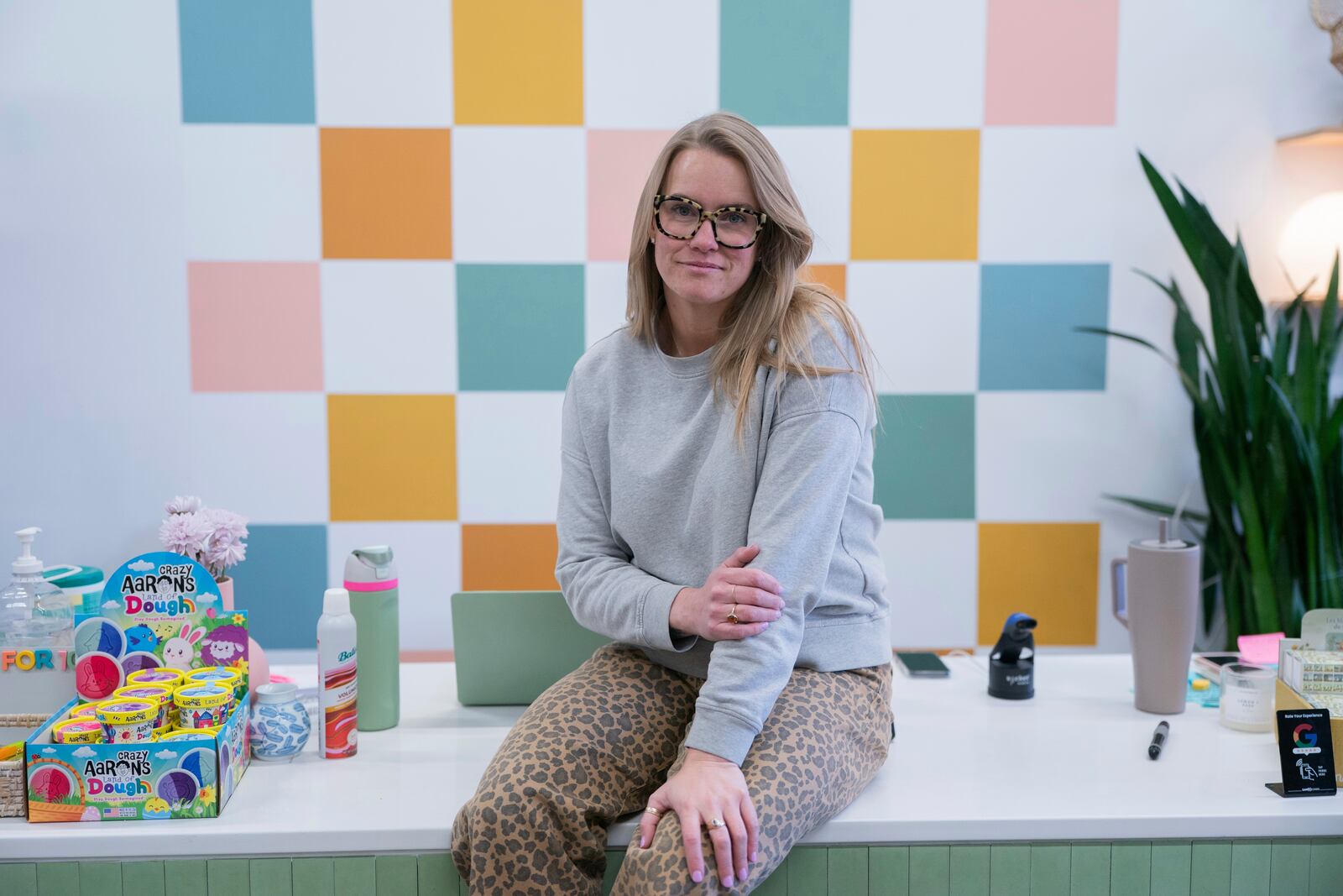 Elizabeth Mahon, owner of the baby store Three Littles, poses for a photo at her Union Market location in Washington, on Wednesday, April 16, 2025. (AP Photo/Nathan Howard)