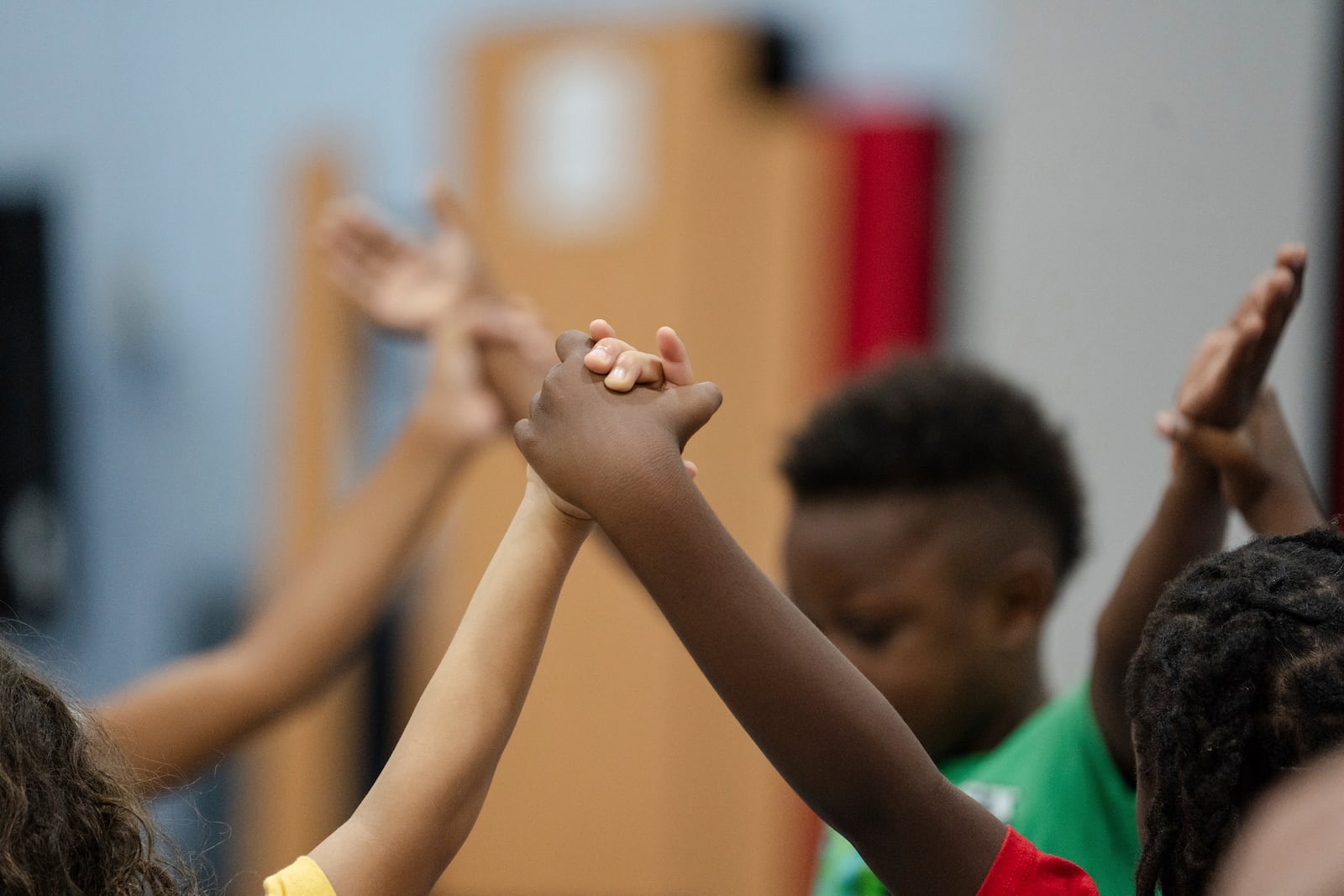 Children hold hands while participating in activities during the East Providence Boys and Girls Club Summer Camp at Emma G. Whiteknact Elementary School on Thursday, July 10, 2025, in Providence R.I. (AP Photo/Sophie Park)