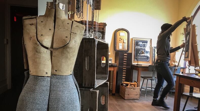 Hedy Riegle of Hedy Riegle Studio sets up her shop at Market Square Building in downtown Miamisburg Monday Nov. 2.