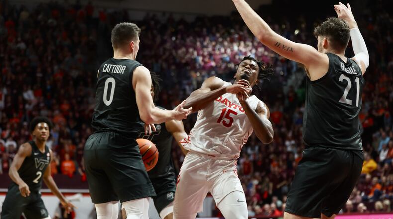 Dayton's DaRon Holmes competes for a loose ball against Virginia Tech on Wednesday, Dec. 7, 2022, at Cassell Coliseum in Blacksburg, Va. David Jablonski/Staff