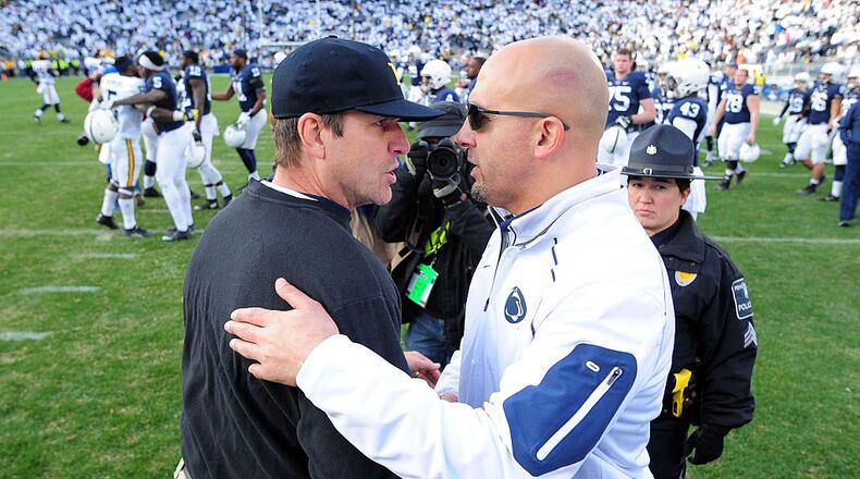 STATE COLLEGE, PA - NOVEMBER 21: James Franklin head coach of the Penn State Nittany Lions congratulates Jim Harbaugh head coach of the Michigan Wolverines after the game at Beaver Stadium on November 21, 2015 in State College, Pennsylvania. The Wolverines won 28-16. (Photo by Evan Habeeb/Getty Images)