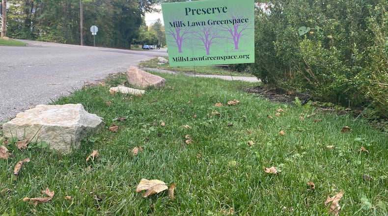 A yard sign reads, "Preserve Mills Lawn greenspace" in Yellow Springs. The sign refers to the lawn and trees behind Mills Lawn Elementary School in Yellow Springs. The controversy over what to do with the small green area behind Mills Lawn Elementary School has affected people across Yellow Springs. Eileen McClory / staff