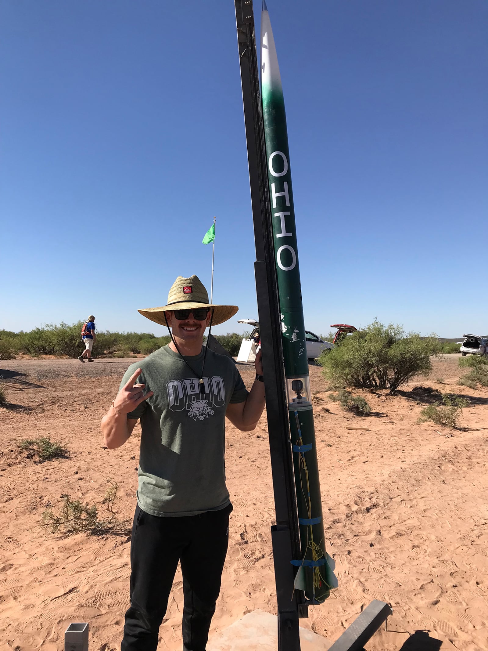 Archie Scott III next to a rocket he built while president of the Ohio University rocket club. He had traveled to Las Cruces, New Mexico for a rocket competition in 2018. CONTRIBUTED