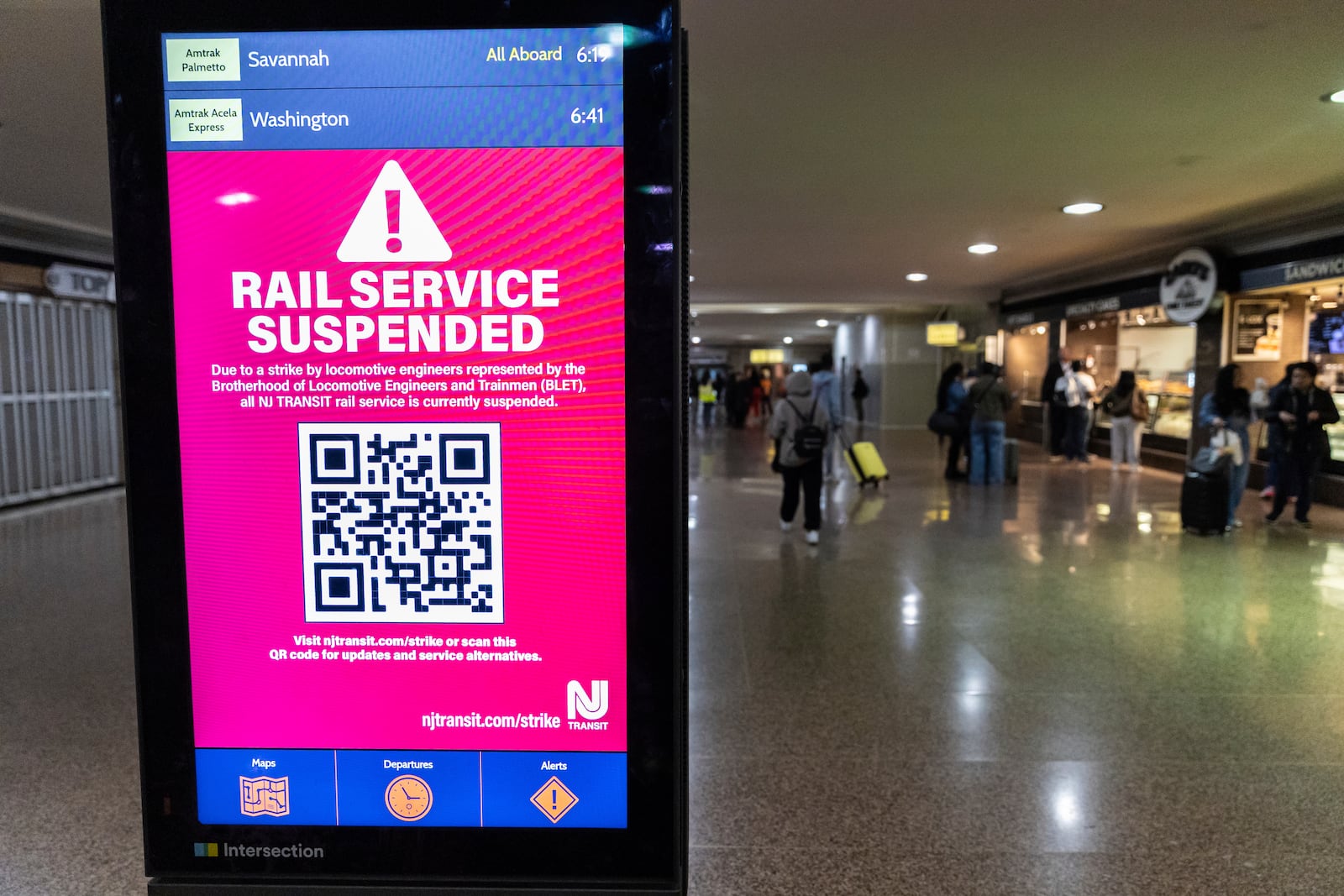 An information screen informing commuters of the rail service suspension, due to the strike by Union members from the Brotherhood of Locomotive Engineers and Trainmen, inside Newark Penn Station on Friday, May 16, 2025 in Newark, New Jersey. (AP Photo/Stefan Jeremiah)