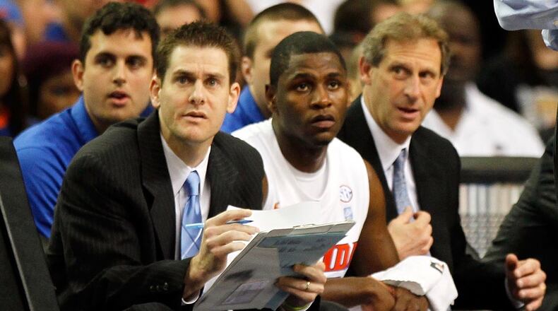 Darren Hertz, left, watches from the Florida bench during the semifinals of the SEC Men's Basketball Tournament at the eorgia Dome on March 12, 2011 in Atlanta, Georgia.