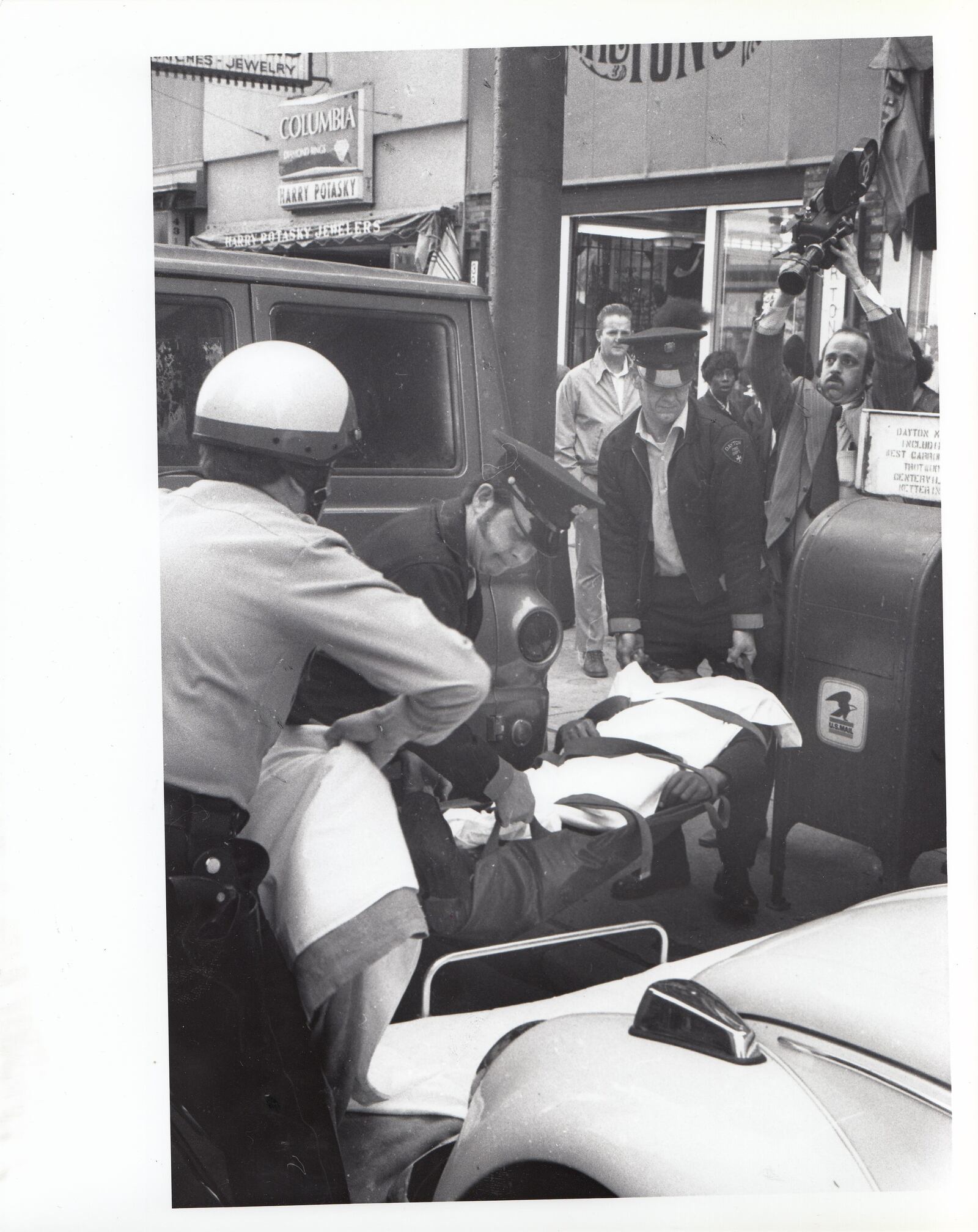 W.S. McIntosh is rushed to a Dayton Fire Department ambulance after he was shot down trying to stop two robbery suspects on the sidewalk, west said of  South Main Street between Third and Fourth streets on March 5, 1974. (note: fire department did not have paramedics at the that time)