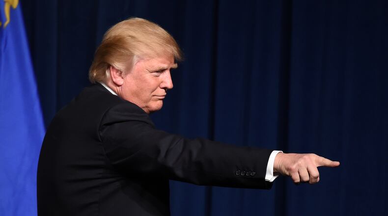 Republican presidential candidate Donald Trump points to supporters after speaking at a caucus night watch party at the Treasure Island Hotel & Casino on February 23, 2016 in Las Vegas, Nevada. The New York businessman won his third state victory in a row in the "first in the West" caucuses. (Photo by Ethan Miller/Getty Images)